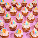 Unicorn Cupcakes by Crumbs & Doilies featuring vanilla sponge with rainbow swirl buttercream and sprinkles on pink background